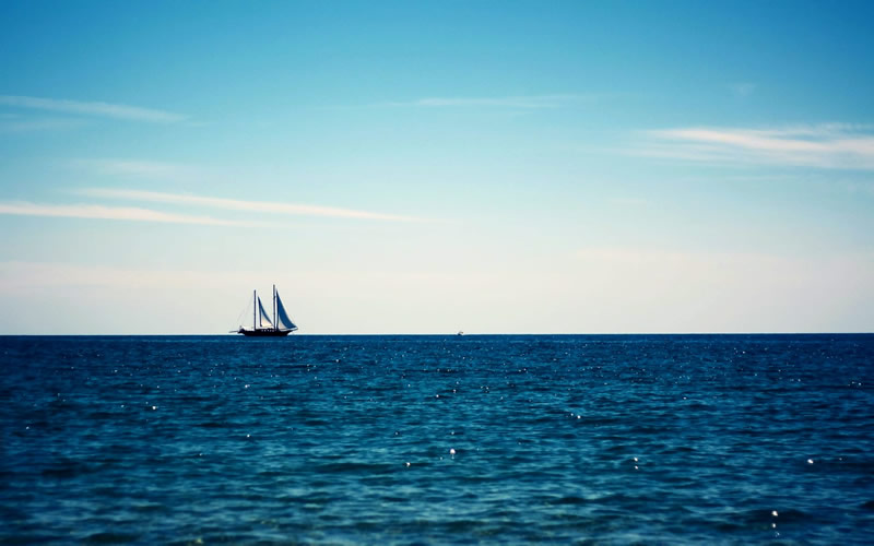 Image of ocean and sailboat